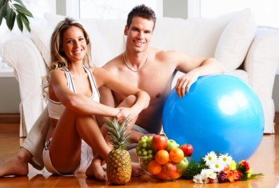 fitness and exercise at home picture of couple sitting near exercise ball in living room in front of couch